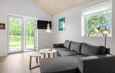 a living room with a couch and a table at 2 Bedroom Amazing Home In Hurup Thy in Sønder Ydby