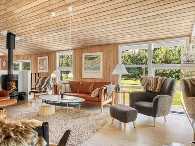 a living room with a couch and a table at Holiday Home Elisenda - 2-2km from the sea by Interhome in Blokhus