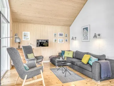 a living room with a couch and two chairs at Holiday Home Carlina - 700m to the fjord by Interhome in Løgsted