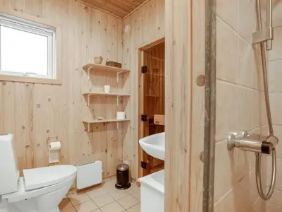 a bathroom with a toilet and a sink at Holiday Home Cate - 900m from the sea by Interhome in Saltum