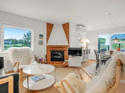 a living room with a couch and a table at Holiday Home Cate - 900m from the sea by Interhome in Saltum