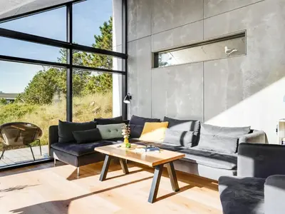 a living room with a couch and a table at Holiday Home Helga - 900m from the sea by Interhome in Blokhus