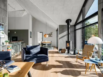 a living room with a couch and a fireplace at Holiday Home Helga - 900m from the sea by Interhome in Blokhus