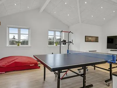 a ping pong table in the middle of a room at Holiday Home Djuna - 550m from the sea by Interhome in Saltum