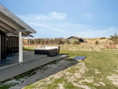 a hot tub on the deck of a house at Holiday Home Djuna - 550m from the sea by Interhome in Saltum