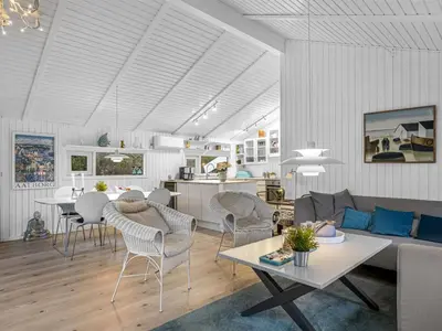 a living room with a couch and a table at Holiday Home Gonda - 2km from the sea by Interhome in Saltum