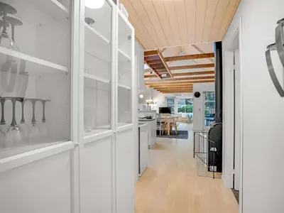 a kitchen and dining room with white cabinets at Holiday Home Adisl - 600m to the fjord by Interhome in Løgsted