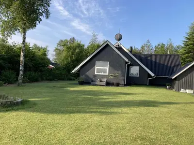 a black house with a large yard at Holiday Home Adisl - 600m to the fjord by Interhome in Løgsted