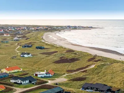 an aerial view of a beach with houses and the ocean at Holiday Home Amina - 50m from the sea by Interhome in Torsted