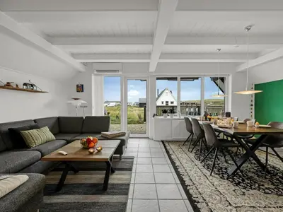 a living room with a couch and a table at Holiday Home Kaja - 150m from the sea by Interhome in Harboør