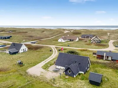an aerial view of a farm with houses and the ocean at Holiday Home Kaja - 150m from the sea by Interhome in Harboør