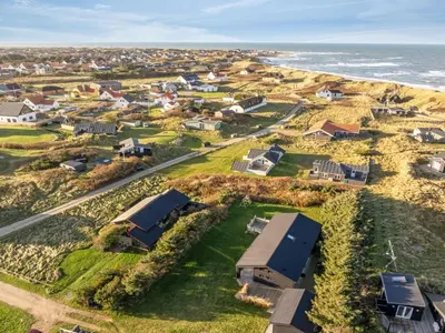 an aerial view of a village with houses and the ocean at Holiday Home Godja - 300m from the sea by Interhome in Torsted