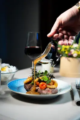 a plate of food on a table with a glass of wine at Cityinn Hotel in Viborg