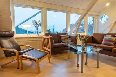 a living room with a couch and a table at Villa Apartments Viborg in Viborg