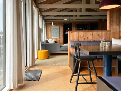 a living room with a table and a couch at Architect-Designed Summer House In Agger in Vestervig