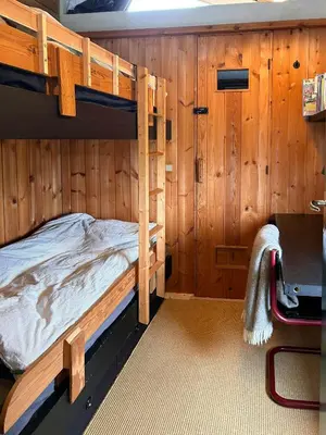 a bedroom with two bunk beds and a desk at Architect-Designed Summer House In Agger in Vestervig