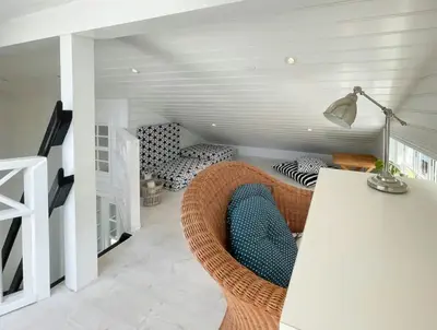 a living room with a chair and a couch at Home With Sauna Near Klitmøller in Thisted