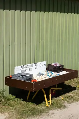 a table with a sign on it next to a wall at North Jutland Nature Near Thorup Beach in Fjerritslev