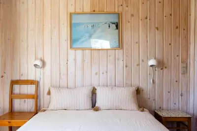 a bedroom with a bed and a picture on the wall at North Jutland Nature Near Thorup Beach in Fjerritslev