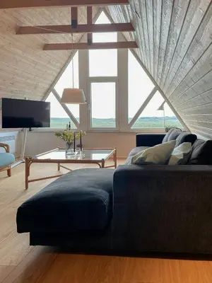 a living room with a couch and a table at Architect-Designed Gem At The West Coast in Pandrup