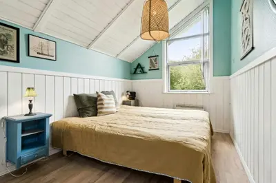 a bedroom with a bed and a window at Home By Limfjord Where Sea And Sky Meet in Hurup