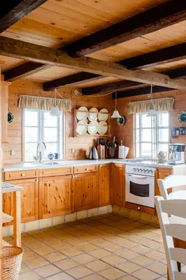 a kitchen with wooden cabinets and a stove at Nature Gem 5 Metres From Limfjord in Roslev