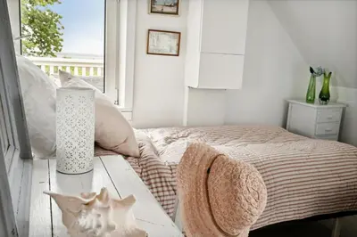 a bedroom with a bed with a table and a window at Nature-Close Home Near Beach At Limfjorden in Thyholm