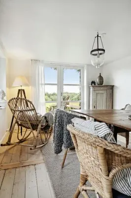 a dining room with a wooden table and chairs at Nature-Close Home Near Beach At Limfjorden in Thyholm