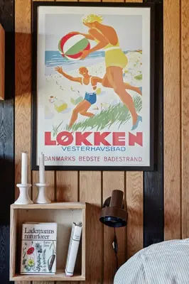 a poster of a woman playing frisbee on a wall at 70'S Style Summerhouse Near Løkken in Løkken
