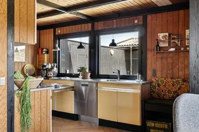 a kitchen with a sink and a window at 70'S Style Summerhouse Near Løkken in Løkken