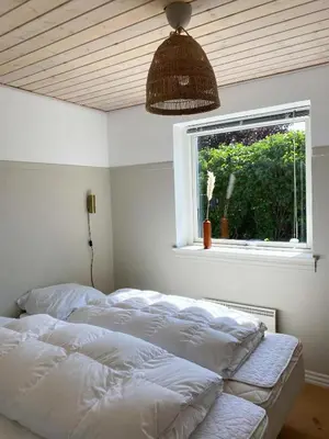a bedroom with three beds in front of a window at Summer House With Panoramic View Near Doverodde in Doverodde