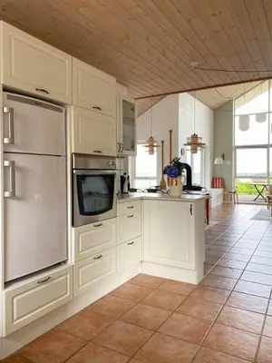 a kitchen with white cabinets and a counter top at Summer House With Panoramic View Near Doverodde in Doverodde