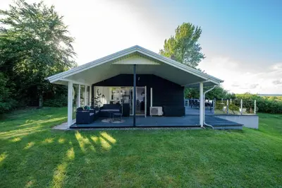 a pavilion with a deck in a yard at Panoramic View And Terrace In Charming Home in Højslev