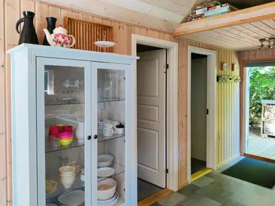 a white cabinet with dishes in it in a room at Home Near Beach With Wilderness Bath in Sindrup
