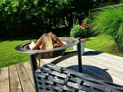 a tray of bread on a table next to a chair at Home Near Beach With Wilderness Bath in Sindrup