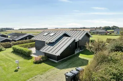 an aerial view of a house with a roof at Cozy Home By Limfjord With Bathing Jetty in Snedsted
