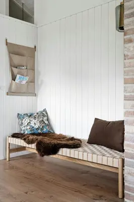 a bed in a room with a white wall at Cottage At Feggeklit With Limfjord Views in Nykøbing Mors