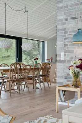 a dining room with a table and chairs at Cottage At Feggeklit With Limfjord Views in Nykøbing Mors