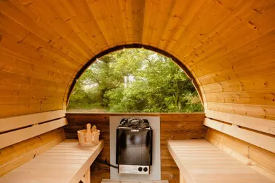 an inside view of a wooden cabin with an arched window at Bright And Lovely Summerhouse In Løkken in Løkken