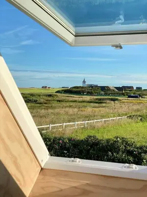 a view of a farm from the window of a house at Renovated Farmhouse In Architectural Style in Lemvig