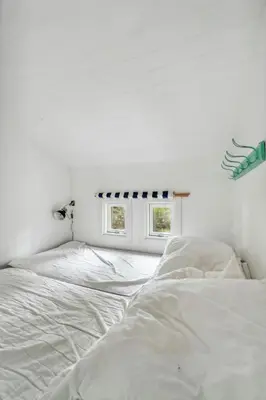 a white bedroom with a bed and a window at Warm Colors And Beautiful Outdoors In Thy in Sønder Ydby