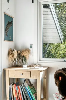 a room with a table with books and a window at Warm Colors And Beautiful Outdoors In Thy in Sønder Ydby