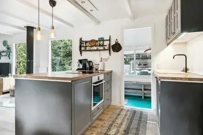 a kitchen with stainless steel appliances and a sink at Warm Colors And Beautiful Outdoors In Thy in Sønder Ydby