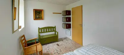 a bedroom with a bed and a green dresser at Peaceful Summer House Near Limfjorden in Nykøbing Mors