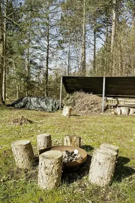 a park with a tree stump table in the grass at Authentic Friis & Moltke House In Lundo's Nature in Højslev