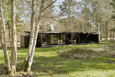 a house in the middle of a forest at Authentic Friis & Moltke House In Lundo's Nature in Højslev
