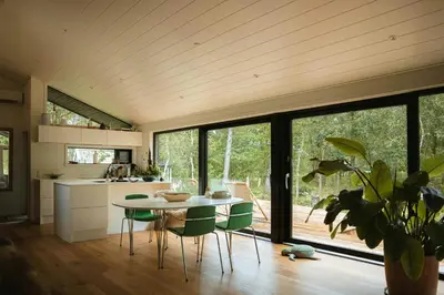 a kitchen and dining room with a table and chairs at Summer House At Thyholm With Fjord View in Thyholm