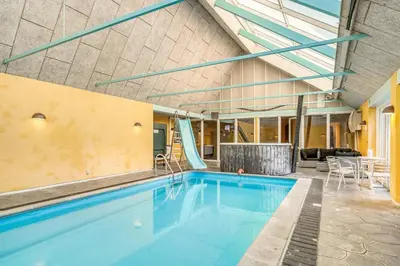 a swimming pool in a building at Large Holiday Home With Pool And Spa In The Middle Of Blokhus Town, Close To The North Sea in Blokhus