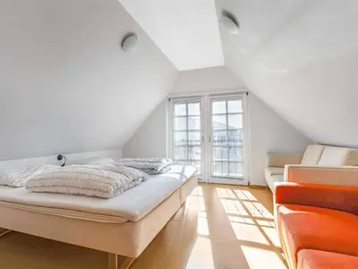 a white room with a bed and a window at Cozy Family Retreat - By Traum Ferienwohnungen in Blokhus