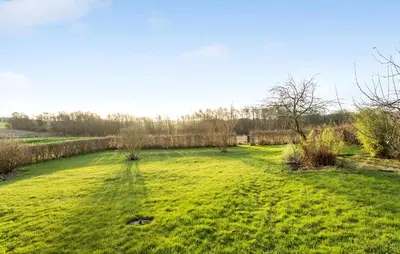 a field with green grass and a fence at 2 Bedroom Nice Home In Roslev in Roslev